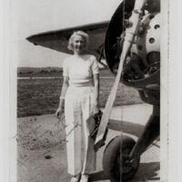 Margaret McCormick standing beside an airplane